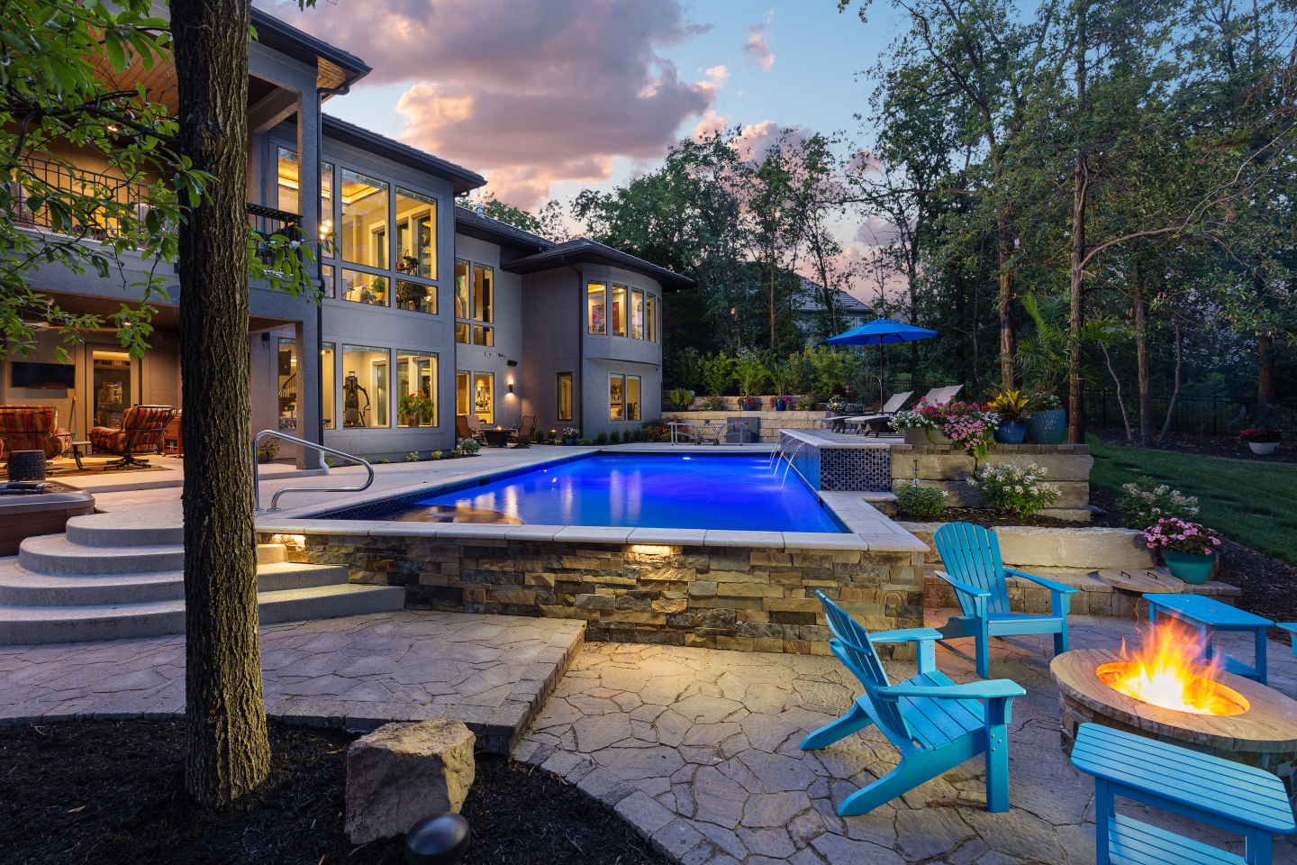 Evening at outdoor pool with firepit and waterfalls