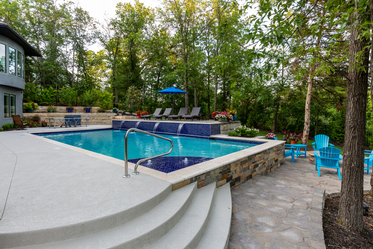Outdoor pool with waterfalls and ping-pong table